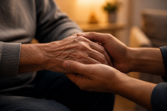 Caregiver holding hands with a loved one with Parkinson's disease — caregivers often notice the smell of Parkinson's before a formal diagnosis